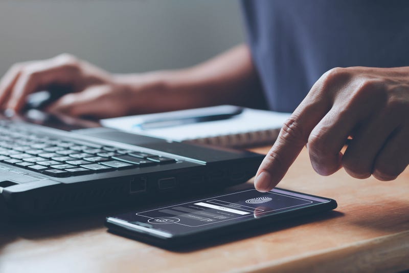 Computer and phone indicating two-step verification cyber security